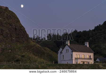 A Image Of A Pretty House On A Moonlit Evening