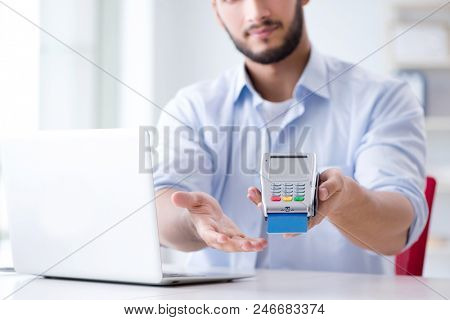 Man processing credit card transaction with POS terminal