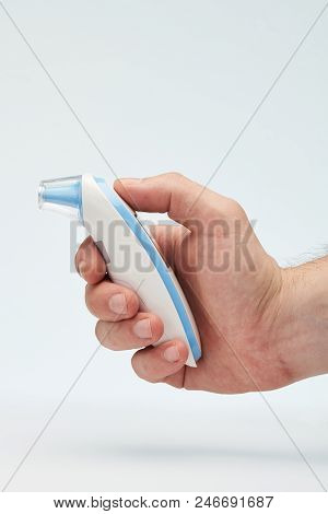 Profile Of Infared Thermometer In Hand Isolated On White Background