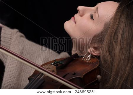 Passionate Violin Musician Playing On Black Background