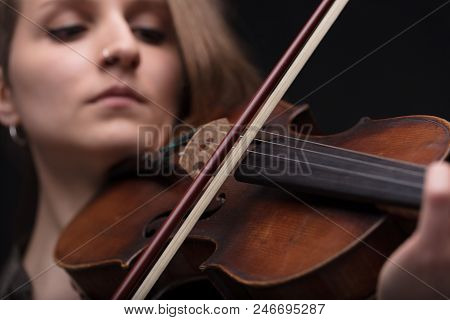 Passionate Violin Musician Playing On Black Background
