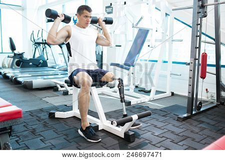 Young Amputee Man Doing Exercises In Gym