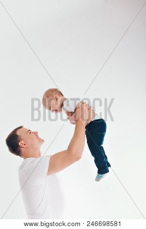 Family Portrait On White Background. A Man Lifted A Girl Up. The Trust Business Partners
