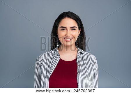 Charming Smile. Gorgeous Dark-haired Woman Wearing A Striped Shirt On Top Of A Burgundy T-shirt And 
