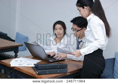 Group Of Young Asian Business People Working Together With Laptop Computer At Workplace Of Office. T