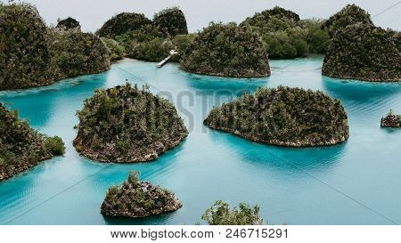 View From The Top Viewpoint Of Pianemo Island Overgrown With Jungle Plants, Surrounded By Shallow Bl