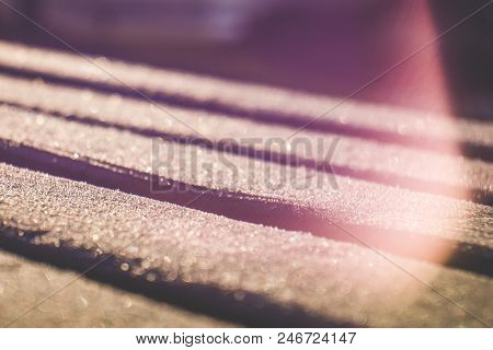 Close Up Of Light Leaks And Wooden Planks Covered With Sparkling Hoar Frost In Free Lensing Techniqu