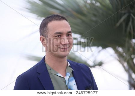 Chinese actor Huang Jue attends the 'Long Day's Journey Into Night (Di Qui Zui Hou De Ye Wan)' Photocall during the 71 Cannes Film Festival at Palais des Festivals on May 16, 2018 in Cannes,  France. 