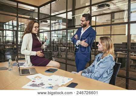 Fun At Work. Gay Three Colleagues Conducting Meeting And Chortling