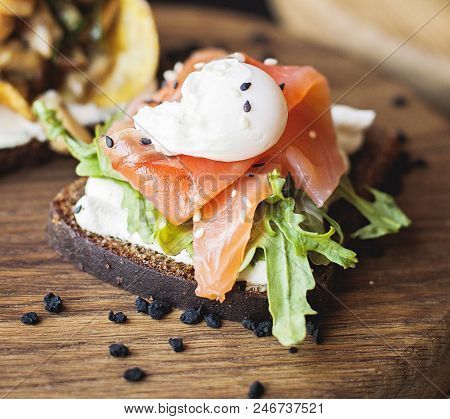 Danish Smorrebrod With Red Salmon Fish And Egg On Wooden Board