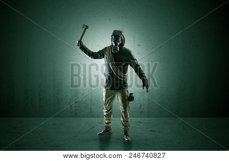 Bad agent in a dark room with arms on his hand and gas mask