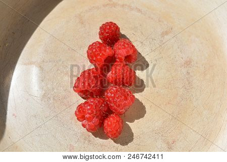 On A Metal Base Laid Eight Pieces Of Raspberry Fruit From The Village Washed Under The Water
