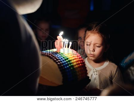 Girl With Birthday Cake With Caldles Wishing In Darkness