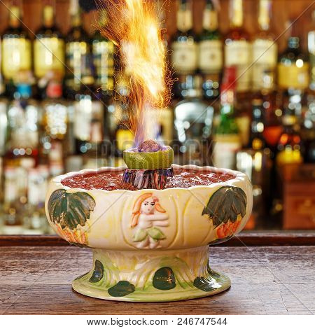 Cocktail With Fire Zombie Volcano. Extra Strong Cocktail On The Bar. Zombie Cocktail - Dark And Ligh