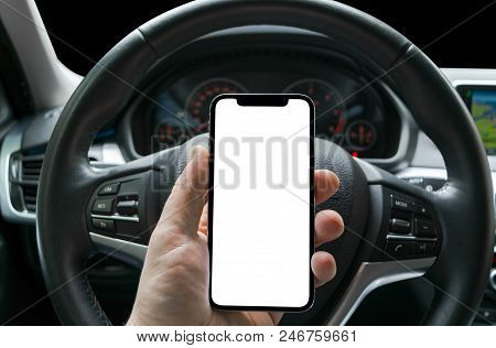 Male Hand Using Smartphone In Car. Man Driving A Car. Smartphone In A Car Use For Navigate Or Gps. M