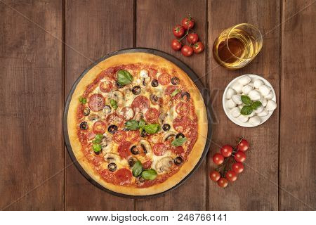 Overhead Photo Of Pepperoni Pizza With Glass Of White Wine, Cherry Tomatoes And Mozzarellini Cheese,