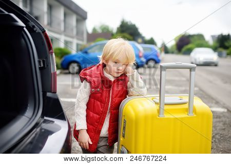 Tired Toddler Boy Ready For Going To Road Trip With His Parents. Automobile Trip In The Countryside.