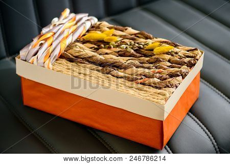 Holiday Decor Concept. Handmade Gift Box Wrapped With Simple Brown Paper And Decorated With Ropes On