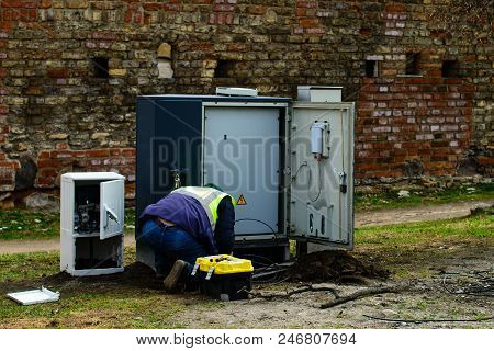 Electric Technical Man Repairing On Street Outdoors