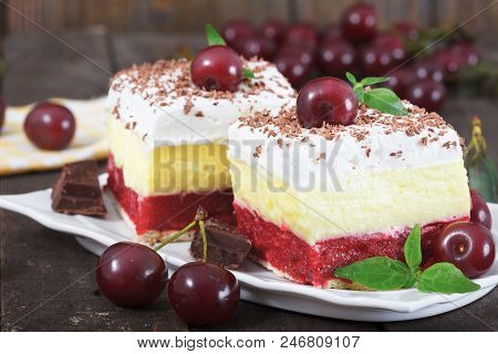 Two Pieces Of  Homemade Cherry Cake With Vanilla And Whipping Cream. Cherries On Top Of The Cakes. R