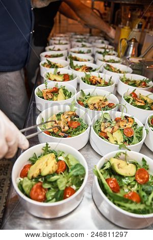 Hands Preparing A Shrimp Salad At An Industrial Kitchen. Concept Of Healthy Food, Selective Focus.