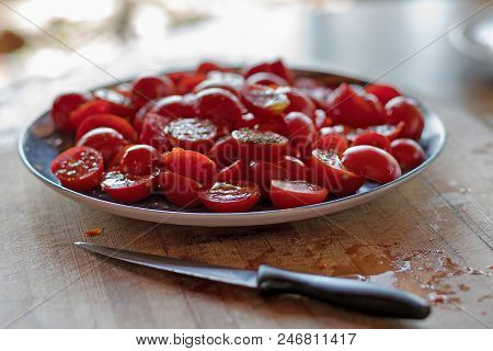Fresh Cherry Tomatoes Under Oil And Seasoning On The Table, Summer Terrace. Concept Of Healthy Food,
