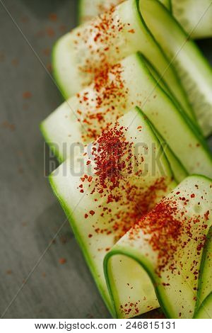 Ground Red Sumac Berries sprinkled on cucumber slice