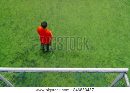 Blurred Background Of Amateur Football Player Playing On Beautiful Green Field With Sport Light And 