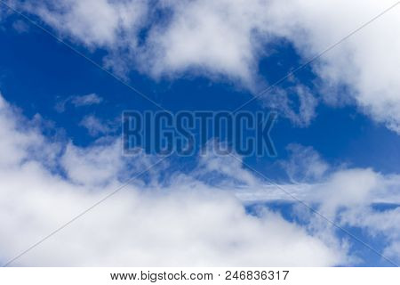 White Clouds With Blue Sky On Background.