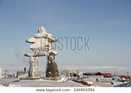 Inukshuk Or Inuksuk Landmark Covered In Snow Found On A Hill In The Community Of Rankin Inlet, Nunav
