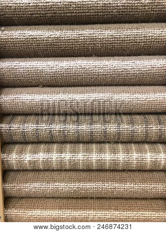Rolled Carpet Samples On Display In A Carpet Shop With A Variety Of Brown To Beige Colour Options An