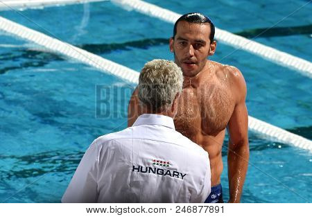 Budapest, Hungary - Jul 17, 2017. GERENDAS Gyorgy second trainer congratulates to GOR-NAGY Miklos (HUN) player. FINA Waterpolo World Championship was held in Alfred Hajos Swimming Centre.