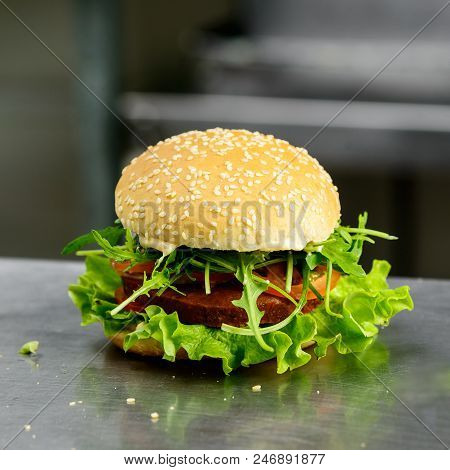 Tasty Yummy Veggie Quinoa Chickpeas Burger With Tomotoes, Lettuce And Spinach On The Table, Selectiv