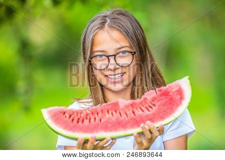 Cute Young Teen Grirl Holding In Hands Watermelon In Garden.