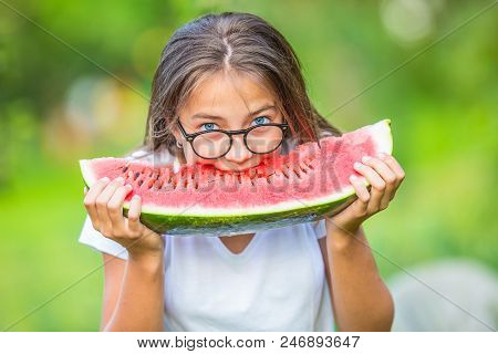 Cute Young Teen Grirl Eating Watermelon In Garden.