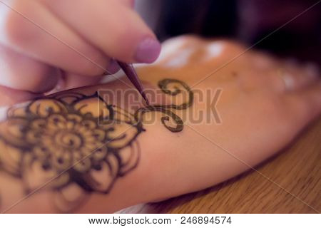 Drawing Process Of Henna Menhdi Ornament On Woman's Hand. Beauty Concept