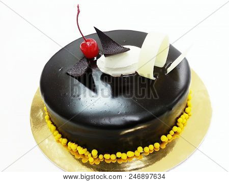 Chocolate Cake With Sherry On White Background.