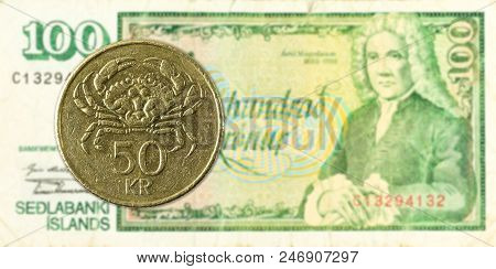 50 Icelandic Krona Coin Against 100 Icelandic Krona Bank Note