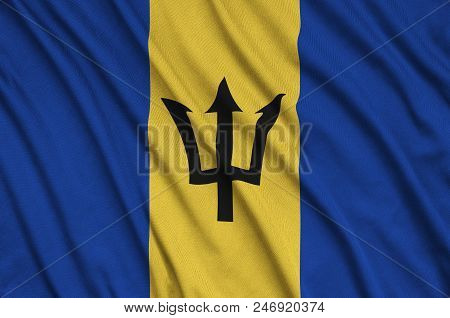 Barbados Flag  Is Depicted On A Sports Cloth Fabric With Many Folds. Sport Team Waving Banner