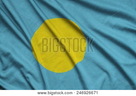 Palau Flag  Is Depicted On A Sports Cloth Fabric With Many Folds. Sport Team Waving Banner