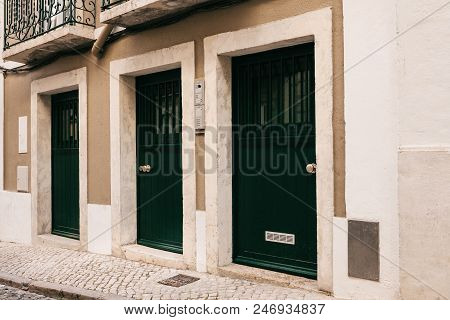 Simple Wooden Entrance Doors Are Arranged In A Row.