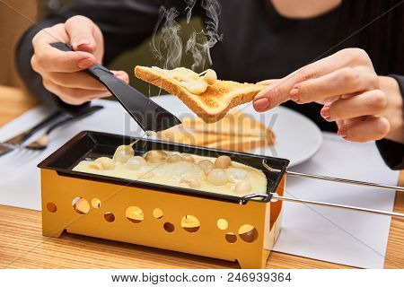 Swiss Food. Cheese Raclette With Mushrooms On Coupelles - Special Small Skillet For A Raclette