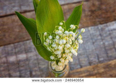Bouquet Of Flowers Beautiful Smell Lily Of The Valley Or May-lily In Glass Vase On Rustic Old Vintag
