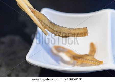 Chopsticks Holding Deep Fired Fish Bone Senbei