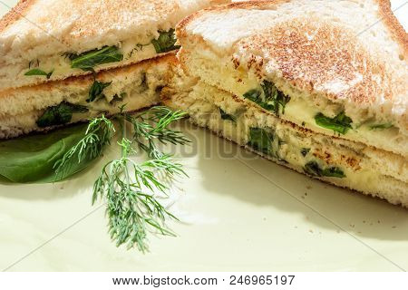 Hot Sandwich With Spinach, Cheese And Herbs, Lying On A Plate