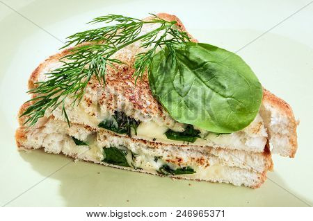 Hot Breakfast Sandwich With Cheese And Fresh Spinach