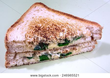 Hot Breakfast Sandwich With Cheese And Fresh Spinach