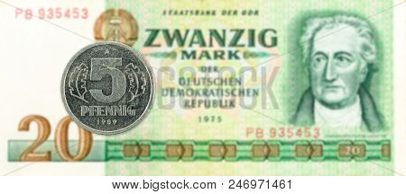5 Pfennig Coin Against Historic 20 East German Mark Bank Note
