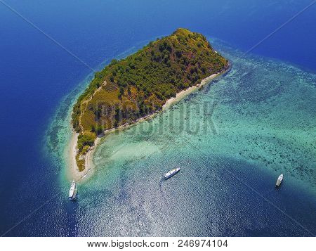 Aerial View Of Beautiful Scenery At Flores Island With Tourist Yatch, Turqouise And Dark Blue Sea