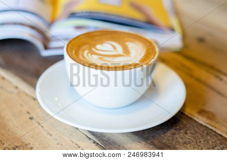 Coffee Cup And Saucer On A Wooden Table .